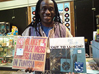 Photo of Will holding two classic Jazz records at the Criminal Records store in Altanta, Georgia.